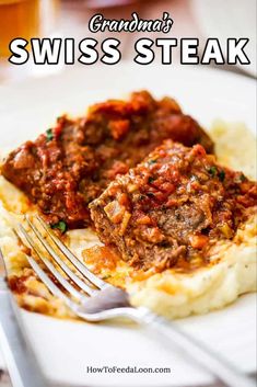 a white plate topped with mashed potatoes covered in meat and sauce next to a fork