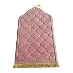 a pink rug with a tassel on the end and a gold fringe around it