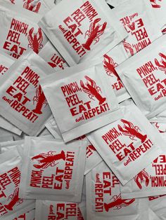 red and white napkins with lobster designs on them are piled up in a pile