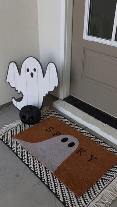 a door mat with a ghost on it