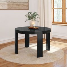 a black table with a plant on top of it