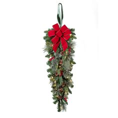 a christmas garland with lights and a bow on it's end, hanging from a wall