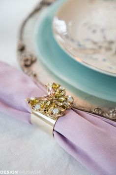 a napkin with a ring on it sitting next to a plate