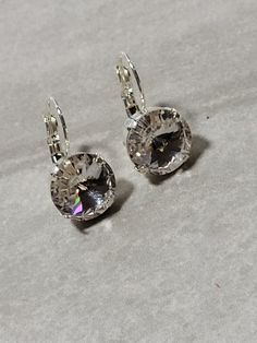 12 mm round Crystal Clear Swarovski Crystal Earrings. Lever back. If you would like a pair to match one of the other colors I have in 12 mm Rivoli Necklaces -please message me! Matching necklaces can be found here!  https://www.etsy.com/listing/1248200795/crystal-beaded-necklace-anna-wintour?click_key=fa3311446f8c14fa96908faa3c33fd77a9dc72de%3A1248200795&click_sum=13c7a753&ref=shop_home_feat_1&pro=1&frs=1 https://www.etsy.com/listing/1274943165/anna-wintour-necklaces-swarovski?click_key=cd792e8c Round Crystal Earrings For Party, Classic Crystal Earrings For Anniversary With Lever Back, Round Crystal Earrings With Ear Wire For Anniversary, Crystal Round Earrings For Anniversary, Classic Round Crystal Earrings With Prong Setting, Clear Round Wedding Earrings, Classic Round Crystal Earrings, Silver Round Crystal Earrings, Formal Silver Hypoallergenic Crystal Earrings