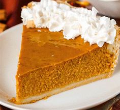 a slice of pumpkin pie with whipped cream on top