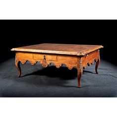 an old wooden coffee table with drawers on one side and a drawer on the other