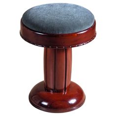 a wooden stool with a blue cushion on it's backrest and foot rest