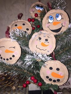 paper plate snowmen are hanging from a christmas tree