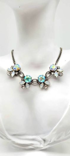 "Aurora Borealis Crystal Necklace, Clear Crystal Bib Necklace, Vintage Rhinestone Costume Jewelry, Round Crystal Necklace, Sorrelli Necklace Measurements: 16\" with a 4\" extender chain. Bib is 1\"L by 3\"W. Metal: Silver Tone Findings: Hook Closure, easy on and off! Finish: Antiqued, Matte Aurora Borealis crystals are simply MAGICAL. There is something so intriguing about stones that seem to transform colors right in front of your eyes! Not to mention they give off the most INTENSE and BREATHTAKING sparkle! From clear to blue to pink to purple to gold and back again, they are simply GORGEOUS! These aurora borealis crystals (and all other crystals in this piece) are SWAROVSKI CRYSTALS that have been set by hand by jewelry to the stars company Sorrelli. Sorrelli uses only the highest qualit Crystal Rhinestone Jeweled Pendant Necklace, Jeweled Crystal Rhinestone Pendant Necklace, Jeweled Pendant Rhinestone Necklace, Aurora Borealis Crystal, Bib Necklaces, Bib Necklace, White Opal, Vintage Rhinestone, Clear Crystal