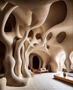 the interior of a cave like building with trees growing out of it