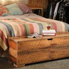 a bed sitting next to a wooden dresser on top of a floor