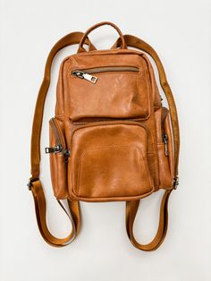 Get ready to elevate your style with the Reese Multi-Way Sling/Backpack! Available in both camel and black, this versatile bag boasts 9 spacious pockets for all your essentials. Stay on trend while staying organized - this fashionable and useful bag has got you covered.