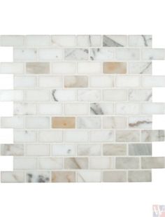 white marble tile with brown and beige stripes on the back wall, in an angled pattern