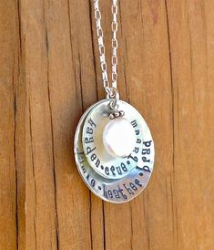 These 1" & 3/4" solid sterling silver discs are gently textured, hand stamped with your custom personalization and then gently cupped to cradle the beautiful freshwater coin pearl & Bali silver drop.  Put the names of your children, meaningful dates, descriptive words, etc. . . .whatever your heart desires!***Character limit on this necklace (spaces count as a character):Large disc - 18Small disc - 22Each necklace comes hung on a beautiful 18" sterling silver chain. I also include a smal Grandma Jewelry, Mom Necklace Personalized, Mother Necklace Personalized, Descriptive Words, Bali Silver, Jewelry Personalized, Mothers Necklace, Coin Pearls, Mom Necklace