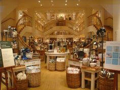 the inside of a store filled with lots of items and baskets on tables in front of them