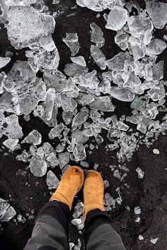 a person standing on top of ice covered ground