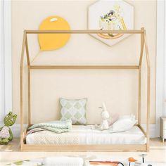 a child's bedroom with a canopy bed and stuffed animals on the floor next to it