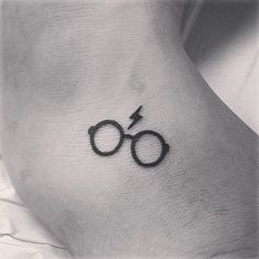 a small harry potter symbol tattoo on the side of a woman's foot,