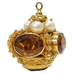 14 Karat Citrine Pearl Crown Pendant. This glorious crown pendant has lovely gold detail and features five oval-cut citrines bezel-set around the crown and at the bottom. The crown measures 32.67mm wide by 35.45mm tall. On the top of the crown under the bail are four round 6.5mm pearls. The pearls are cream in color and have good luster. The total gold weight is 21.8 grams. Vintage Gold Jewelry With Crown Design, Etruscan Jewelry, Pearl Crown, Crown Pendant, Art Jewelry Contemporary, Amulets, Gothic Jewelry, Gold Gold, Art Jewelry