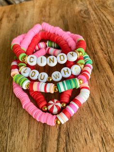 the candy bracelets are stacked on top of each other, with words that spell out candy