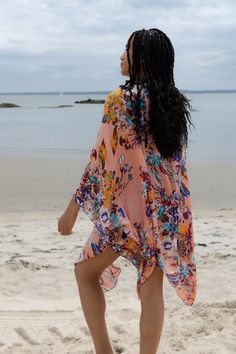 Give your casual wardrobe a stylish lift with this elegant Lasdon Kimono! Floral prints breathe a new life to the apparel, and a long flowy silhouette makes this stunner an ideal pick for all seasons! Materials: 100% Rayon 2PLY Size: 34" x 44" Made in India Orange Beachwear Kimono For Vacation, Casual Floral Print Kimono For Beach, Flowy Floral Print Kaftan With Kimono Sleeves, Flowy Floral Print Kimono For The Beach, Orange Kimono For Vacation With Kimono Sleeves, Pink Beachwear Kimono For Spring, Floral Print Kaftan With Kimono Sleeves For Beach, Flowy Floral Print Kimono For Beach Season, Floral Print Kaftan For Summer