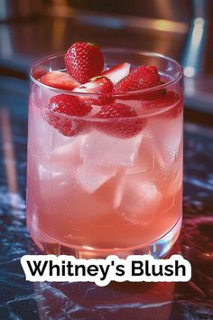 a close up of a drink in a glass with strawberries on the rim and text that reads whitney's bush