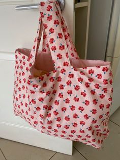 "Welcome to my shop! This eco friendly Hobo is handmade with imported designer cotton fabric and has a gorgeous  floral print. The matching pink lining  and the handles are  made from pure homespun cotton. The Hobo bag is light as a feather  and fits into handbags. size:  Width: 20\" Height: 14\" Handle drop\" 6\" Cool wash on gentle cycle Wonderful gift idea! All my hobos are lovingly  made individually and  are not a mass production." Pink Cotton Bag For Summer, Pink Cotton Bags For Summer, Pink Cotton Beach Bag, Pink Fabric Bags For Summer, Pink Floral Print Bags For Summer, Summer Pink Floral Print Bags, Handmade Cotton Bags For Spring, Spring Handmade Cotton Bags, Summer Cotton Bag With Floral Print