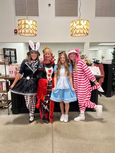 three girls in costumes posing for the camera