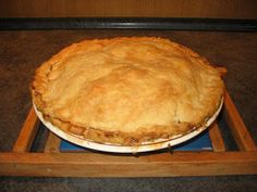 a pie sitting on top of a wooden tray