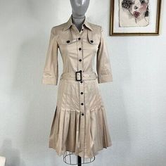 This modern yet classic Burberry London dress has our hearts flutter. Taking a nod from the classic Burberry heritage that we know and love, this cotton dress looks like classic Burberry trench coats, but in a 3/4 sleeve dress style. We love the pleats along the bottom and the dual gun holders on either chest. Great for casual wear or the office!<br>Color variation to pleats at front, side<br>There are a few small stains throughout this dress, though only noticeable upon close inspection and wil Burberry Clothes, Office Color, Trench Dress, Burberry Trench, London Dress, Burberry Trench Coat, Vintage Burberry, Burberry London, Trench Coats