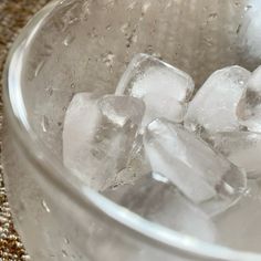 some ice cubes are in a metal bowl