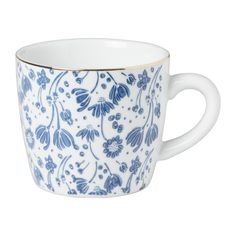 a blue and white cup with flowers on it