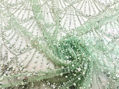 green sequins and beads on sheer fabric