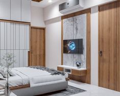 a bedroom with white walls and wood paneling, a tv mounted on the wall