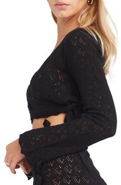 Openwork crochet and a scalloped hem add a breezy vibe to this cover-up sweater with a cropped, wraparound design and side tie closure. True wrap style with side tie closure Surplice V-neck Long sleeves 100% acrylic Hand wash, dry flat Made in Peru Hispanic & Latinx Owned/Founded Fitted Cropped Open Knit Cardigan, Beach Pointelle Knit Fitted Crop Top, Beach Fitted Pointelle Knit Crop Top, Cropped Open Knit Cardigan, Fitted Open Knit Cover-up, Beach Open Knit Long Sleeve Crop Top, Beach Long Sleeve Open Knit Crop Top, Long Sleeve Open Knit Crop Top For Beach, Crochet Crop