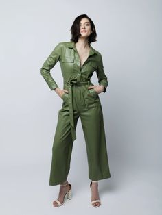 Shop this sleek faux leather jumpsuit long, cuffed sleeves, wide legs, hidden snap front, breast and side pockets and detachable waist tie and elastic waist. Fall Workwear Jumpsuits And Rompers With Belt Loops, Casual Workwear Jumpsuit With Flap Pockets, Utility Style Belted Jumpsuit For Fall, Fitted Utility Jumpsuits And Rompers With Belt, Fitted Belted Utility Jumpsuits And Rompers, Fall Workwear Belted Jumpsuits And Rompers, Spring Long Sleeve Jumpsuits And Rompers With Side Pockets, Fall Jumpsuits And Rompers With Pockets, Fall Season Belted Overall Jumpsuits And Rompers