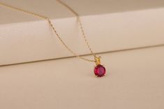 This is a stunning necklace made of solid 10K, 14k gold and silver. It has a round genuine red ruby gemstone with a timeless design and alluring luster, which is suitable for casual wear, business meetings, party occasions, and daily wear. This necklace will make an excellent gift for your wife or mother on her birthday, anniversary and other important occasions. Details of the product Material: 10K and 14K Solid Gold, Silver Gemstone: Ruby Gemstone Gemstone Size: 8 mm Unique Gift For people whom you love; Mom, Girlfriend, Wife, Fiance, Best Friend; Dainty Gift Idea; Valentine's Day Gift, Birthday Gift, Anniversary Gift, Gift For Engagement or Wedding, Promise Gift, Christmas Gift, Black Friday Gift, Mother's Day Gift, International Women's Day Gift, Memorial Gift. By gifting this elegant Classic Red 14k Gold Necklace, Classic Ruby Round Pendant Jewelry, Classic Round Ruby Pendant Jewelry, Elegant Ruby Pendant Birthstone Necklace, Classic Necklace With Lab-created Ruby, Formal Ruby Round Pendant Jewelry, Red Ruby Round Necklaces, Elegant Round Necklace With Lab-created Ruby, Red Gemstone Round Necklace