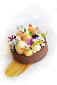 there is a chocolate dessert with flowers on it