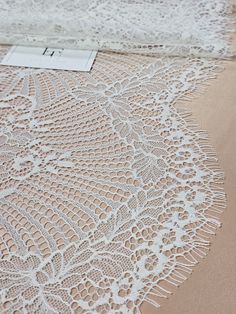 "Quantity available. Please \"Add to cart\" to see available quantity. Ivory lace trimming Both sides scalloped differently Width: 34 cm/13.4 inches Item number: LMT7101 www.LaceToLove.com Price is set for one meter/yard. You will receive the fabric in one continuous piece if you purchase more than 1 meter/yard. IMPORTANT! Maximum one piece length of this lace trimming is 2.85 meters/yards. If you buy more than 2.85 meters/yards of this lace trimming you will receive it in several pieces. Actual color may vary greatly form the color you see on screen. It depends on your devices screen brightness/settings. We recommend you to buy a sample before ordering to see the true color. You can purchase a sample here: https://www.etsy.com/listing/248526479/buy-a-swatchsample?ga_search_query=sample&re White Lace Dress For Ceremony, White Crochet Lace For Ceremony, White Crochet Lace For Ceremonies, Cream Lace Dress With Delicate Details, White Lace Dress With Contrast Lace For Wedding, Cream Lace Dress With Scalloped Details, Cream Lace Dress With Lace Back, Bridal Gown Lace, Garter Lace