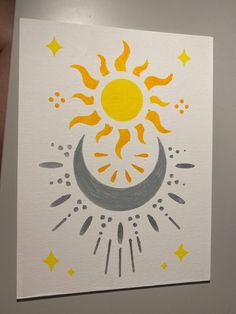 the sun and moon are drawn on white paper with yellow stars in the sky above it