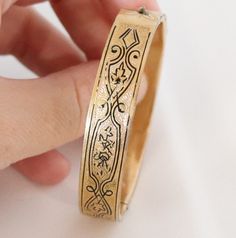 Please note we ship on Tuesdays and Fridays only due to living in a Rural community. (THIS ITEM IS NOT GOLD PLATED IT IS ANTIQUE OR VINTAGE GOLD FILLED PLEASE READ EPLANATION FOR VINTAGE AND ANTIQUE GOLD FILLED JEWELLERY BELOW THE DESCRIPTION) This is a Late Victorian early 1900s  Etched Gold Filled Bangle Art Nouveau Era The bangle has been etched to the front with black enamel tracing. It is in very good antique condition. It has a side open clasp that closes securely. The back has a mirror go Vintage Bangle Bracelet With Decorative Band, Victorian Engraved Bangle For Gift, Vintage Bracelets With Decorative Band As Gift, Antique Gold Cuff Bracelet Collectible, Vintage Gold Bracelet With Intricate Design, Vintage Gold Bracelet For Ceremonial Occasions, Antique Bracelets With Decorative Band As Gift, Vintage Gold Etched Bracelet, Vintage Gold Stamped Bangle