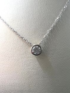 This exquisite diamond pendant necklace is the perfect way to add a touch of luxury to your look. Crafted with 14KT white gold and showcasing a sparkling .15 carat diamond with a bezel setting, it hangs gracefully from a 16-18 inch adjustable chain. Wear it to bring a hint of elegance to any ensemble.Features:-14kt White Gold-0.15 carat Diamond-White Gold Bezel Setting-14kt White Gold Adjustable chain (16-18 in.) Luxury Adjustable Diamond Necklace, White Gold Solitaire Necklace With Bezel-set Round Stone, Cubic Zirconia Solitaire Necklace With Bezel Setting, Diamond White Necklace With Bezel Setting Round, Diamond White Necklace With Round Bezel Setting, Diamond White Necklace With Bezel Setting And Round Shape, Sterling Silver Solitaire Necklace With Bezel Setting, Timeless White Gold Solitaire Necklace With Bezel Setting, Solitaire Diamond Necklace With Round Pendant