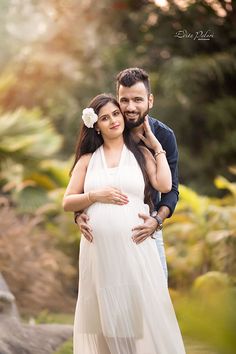 a pregnant couple standing next to each other