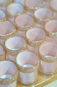 pink and gold glasses are lined up on a table with glitter in them, as if they were for a wedding or special occasion