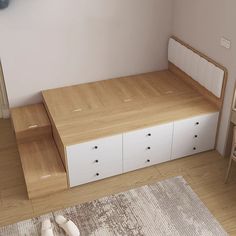 there is a bed with drawers underneath it