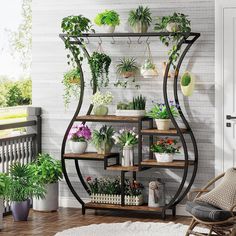 a room filled with potted plants on top of shelves next to a white brick wall