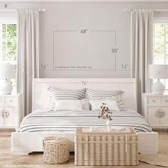 a white bed sitting in a bedroom next to two baskets on top of a table