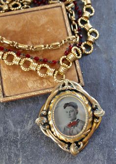 "A Reliquary for a cherished 4 leaf clover and a tinted tintype of a young boy, this gorgeous pendant is a Pinchbeck (named for it's inventor) Mourning Brooch, from the 1800's. Pinchbeck is an alloy of copper (mostly) and zinc, combined to closely resemble gold. It was often used in watchmaking and jewelry. These swivel brooches from the 1800's were most often filled with the hair or picture of a loved one who had passed. This double side brooch had a picture from the early 1900's in it, so I re Memento Mori Victorian, Steampunk Photography, Vintage Statement Jewelry, Assemblage Necklace, Vintage Fans, Brooch Necklace, Four Leaf, Memento Mori, Leaf Clover