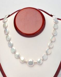 Outstanding, 12mm, white, coin pearl necklace, with a 16mm coin pearl center, surrounded by sterling silver beads.  Sterling silver clasp and a one inch extension chain 17 inches long. For yourself or give as a gift, to be enjoyed by all! Please visit our other Etsy shop: https://www.etsy.com/ca/shop/PearlEarringsEtc Elegant White Round Coin Necklace, Sterling Silver Single Strand Pearl Necklace, White Pearl Necklace With Adjustable Sterling Silver Clasp, Round Mother Of Pearl Necklace For Anniversary, Mother Of Pearl Anniversary Pearl Necklace, Round Mother Of Pearl Drop Necklace, Mother Of Pearl Drop Necklace, Coin Pearl Necklace, South Sea Pearl Necklace