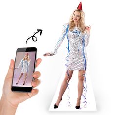 a woman in a silver dress is holding a cell phone and wearing a party hat